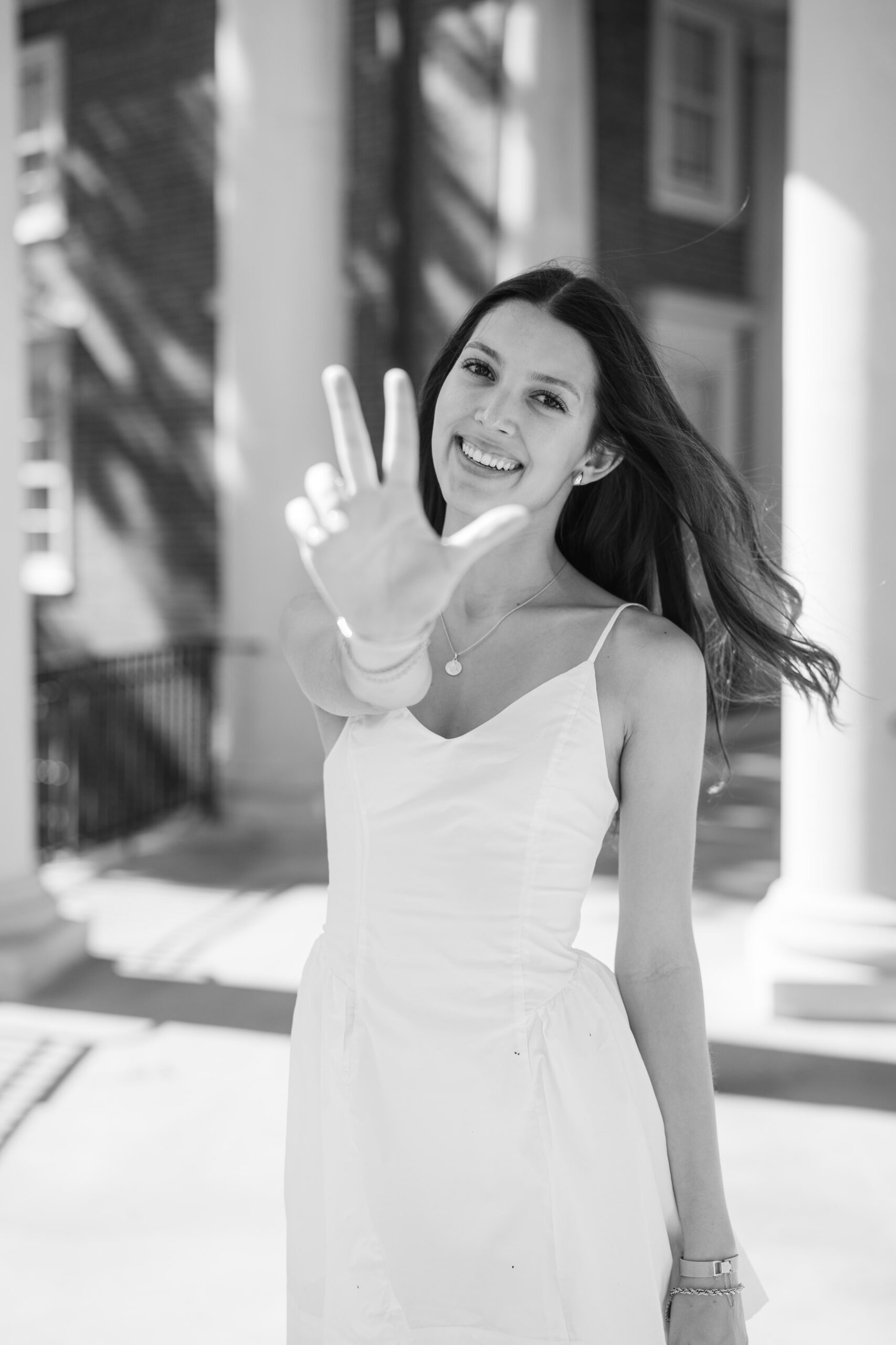 Vanderbilt University graduation photos with the Vanderbilt Anchor Down hand sign by a Nashville college portrait photographer