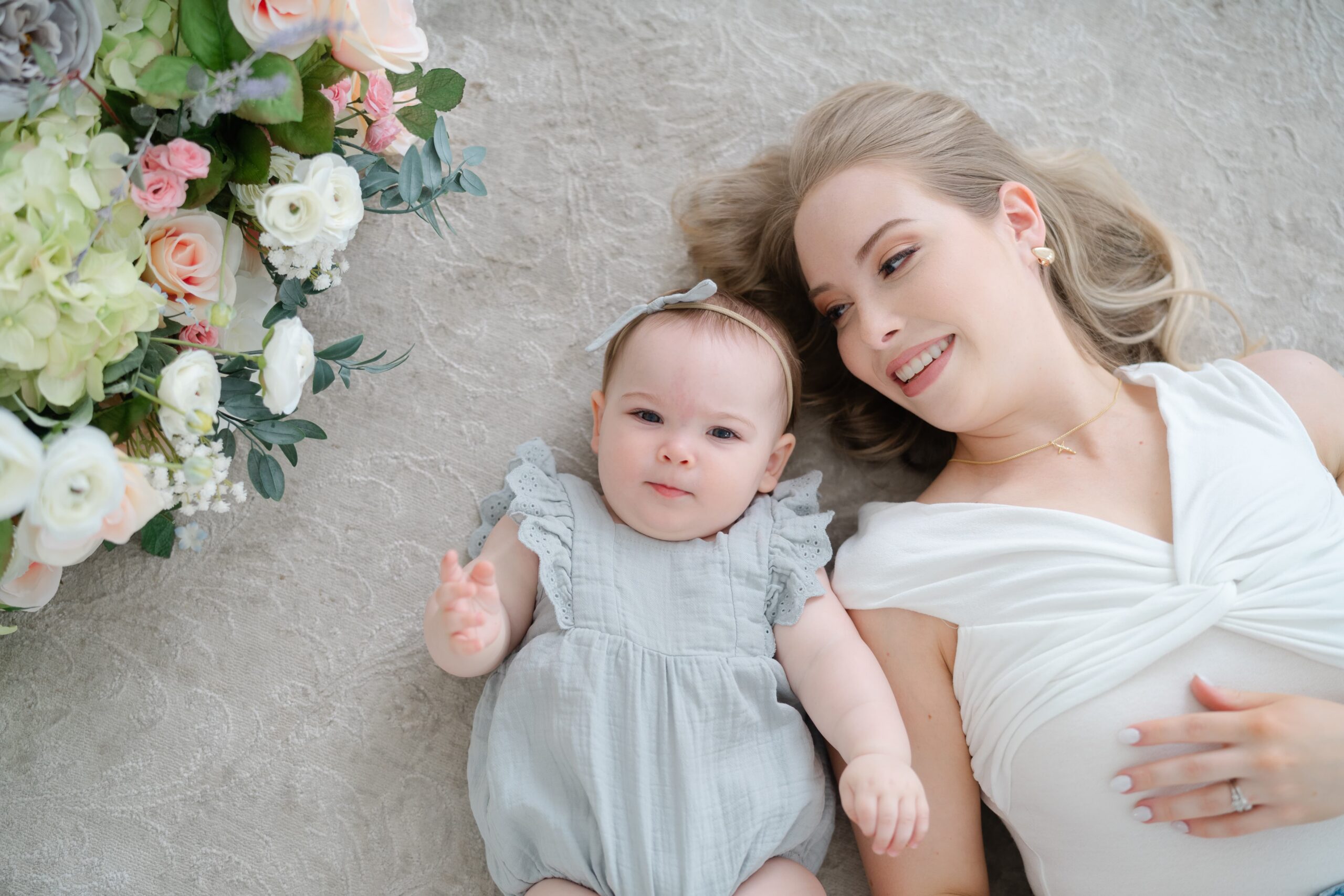 Mother and daughter lying together during mommy and me photos at Studio Ivoire in Franklin TN