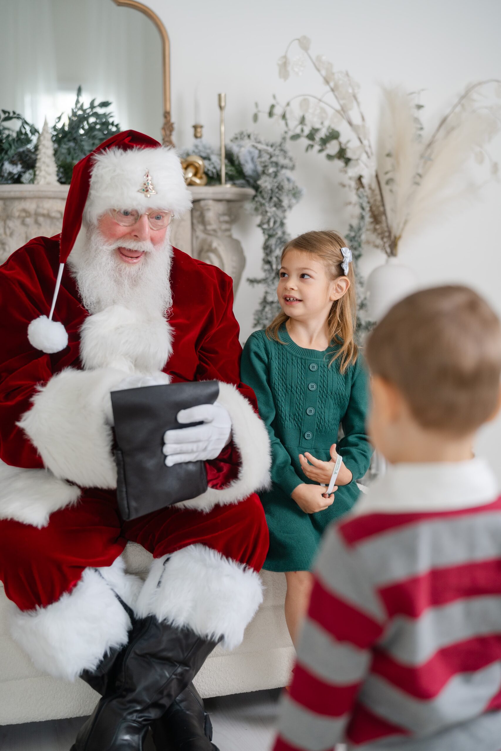 Young girl talking with Santa during a Santa mini session in Franklin Tennessee with Dolly DeLong Photography