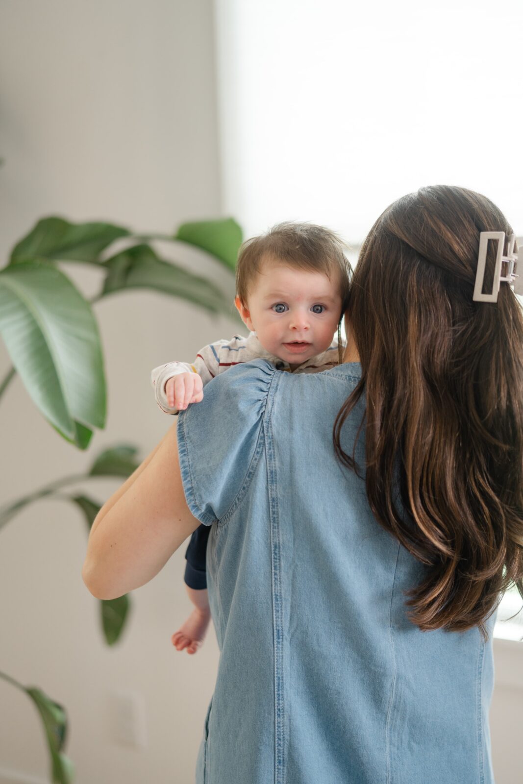 Baby resting on his mom's shoulder during an in home Nashville family photography session
