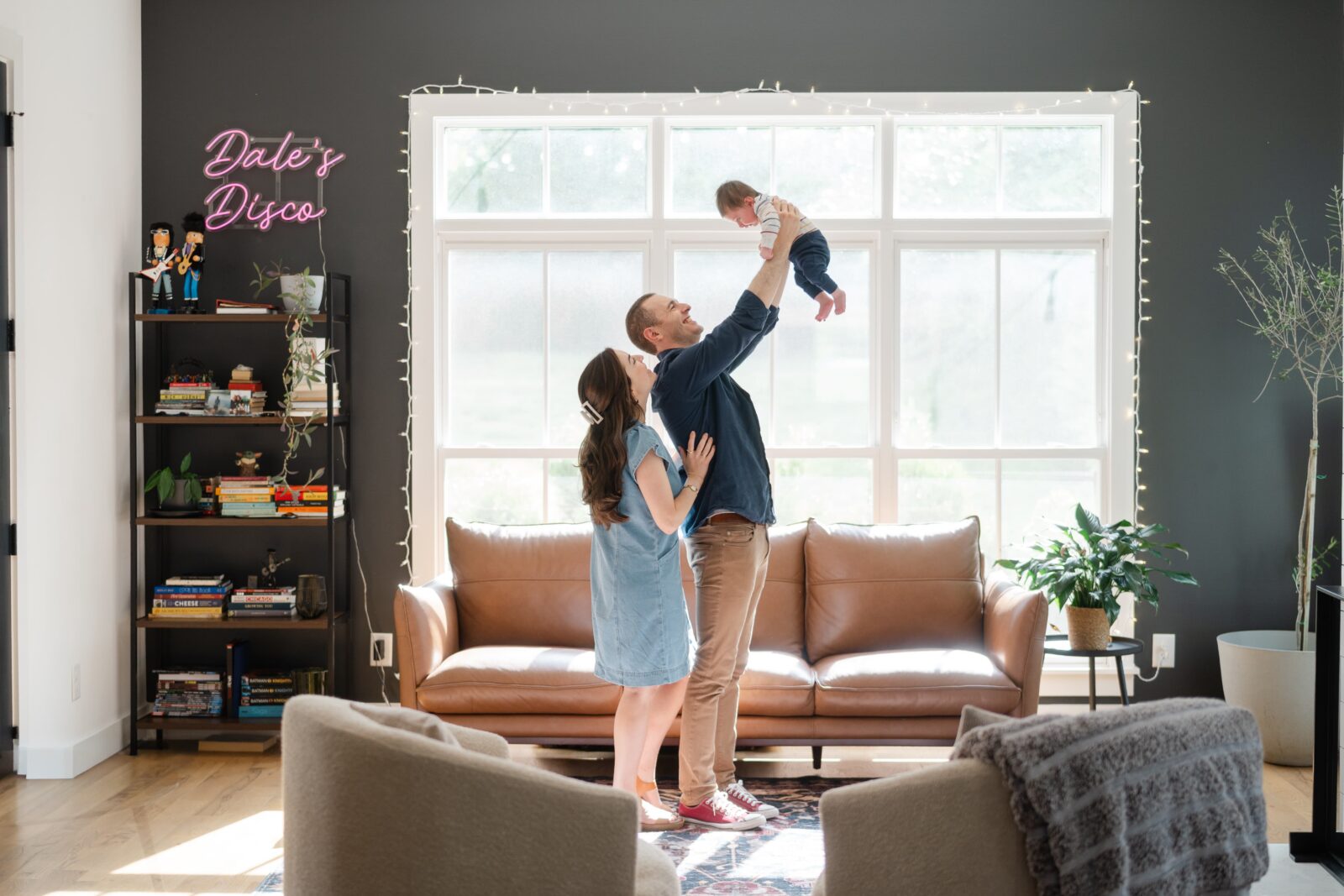 Family playing together in their living room during an at home family photo session in Nashville