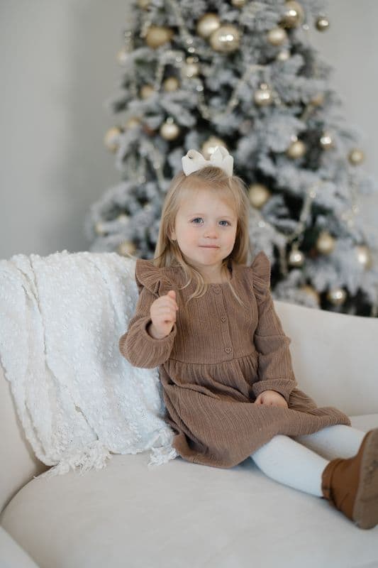 Toddler in neutral brown and cream, one of my favorite Santa mini session outfit ideas